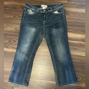 Low rise dark denim straight legs jeans with gems and design on back pockets